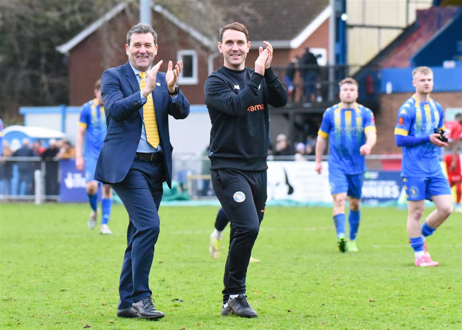 King's Lynn Town manager Tommy Widdrington and coach Mark Hughes acknowledge the supporters at the end of Saturday's 3-0 victory over Spennymoor Town at The Walks. Picture: Tim Smith. (63092526)