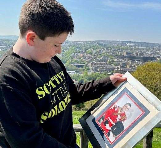 Jack Rigby holds a picture of his dad Royal Fusilier Lee Rigby who was murdered in 2013