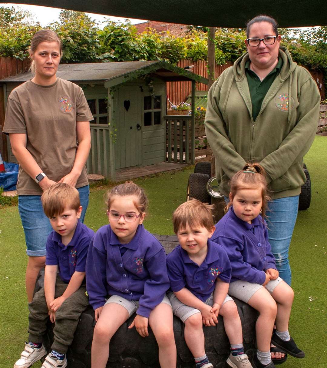 South Wootton Pre-School, pictured left, manager Rose Auker, and right, owner Lisa Carter, with Theo, Evie, Harrison and Poppy at their play area