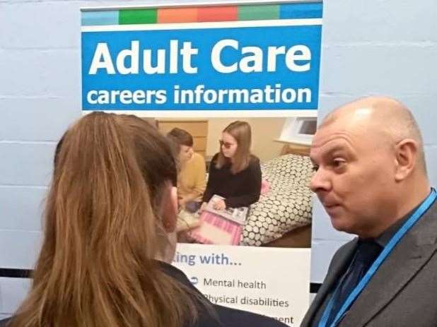 Phil Tilney (right) giving information about a career in adult care