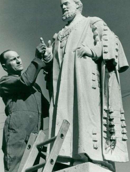 Eric Trigg repairing the statue of Frederick Savage