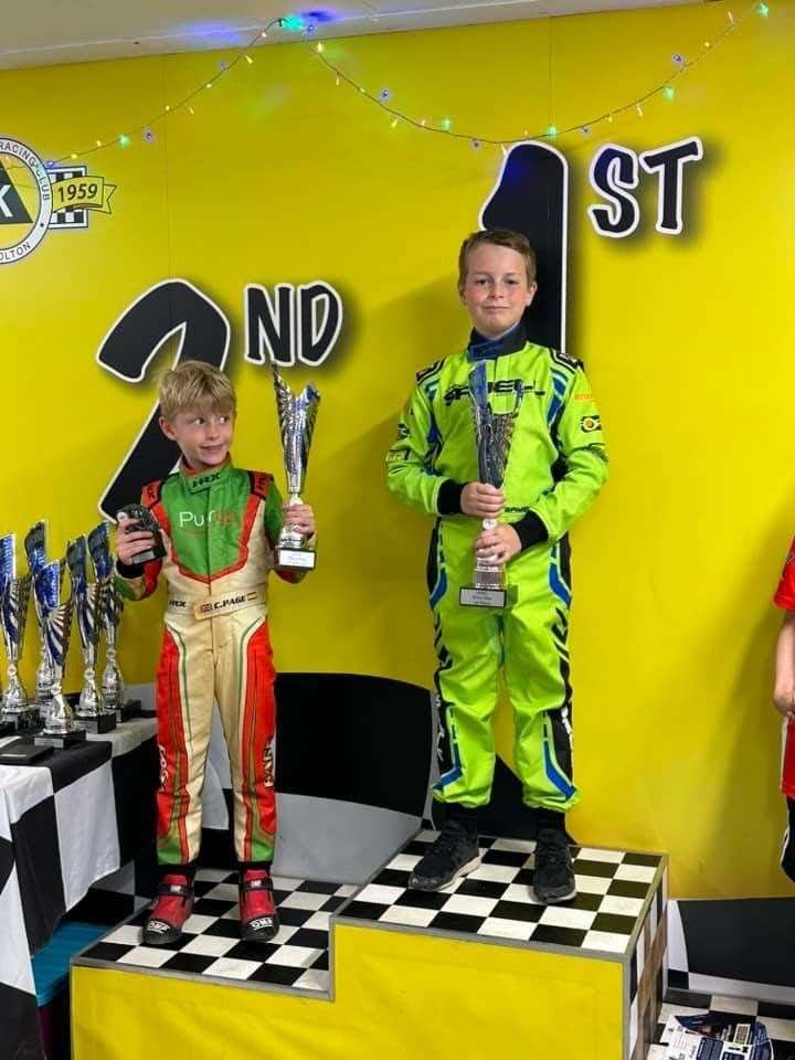 Jenson Sayell on the podium with Charlie Page next to him.