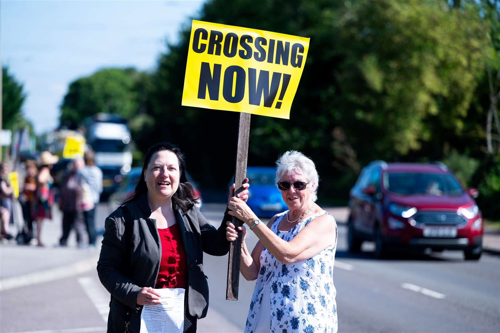 Cllr Alex Kemp (left) joined the protestors who also called for a crossing on the A10. Pictures: Ian Burt