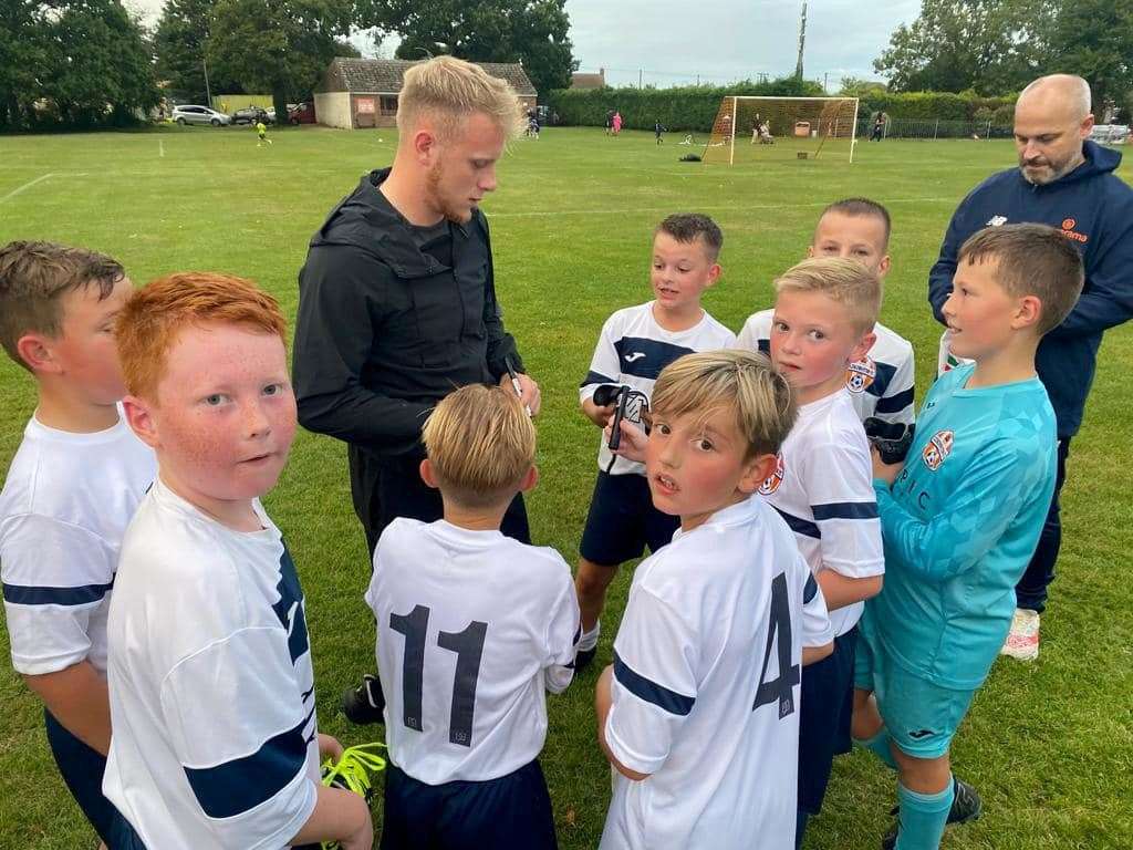 Joe Taylor with Under-11 footballers from Clenchwarton