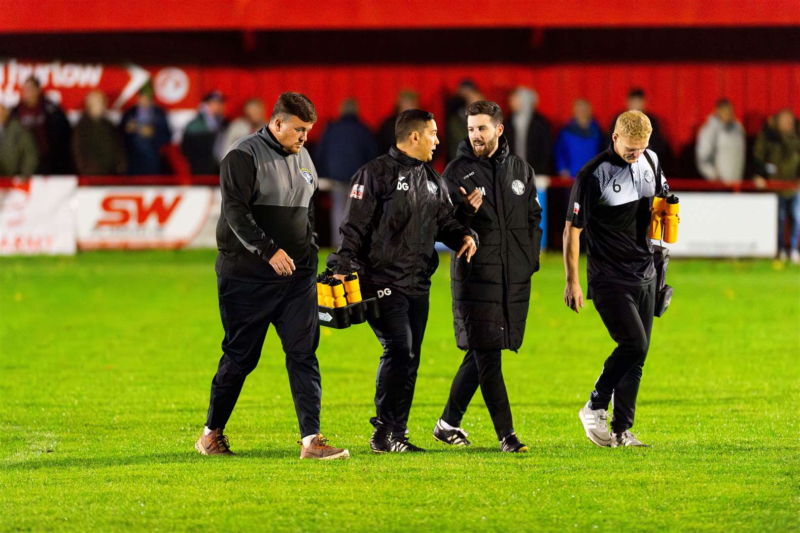 The Heacham management and coaching team leaving the pitch at half-time during Wednesday night's derby clash at the SCL Memorial Field. Picture: Ian Burt