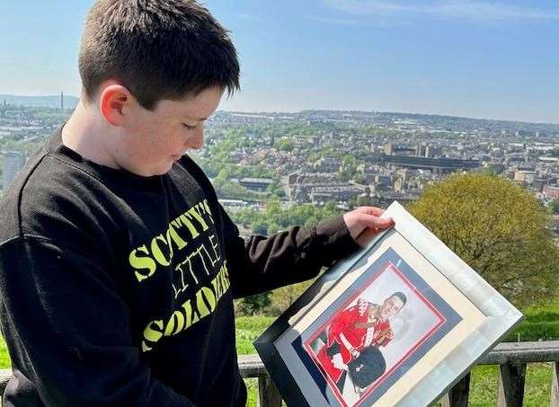 Jack Rigby holding a photo of his dad Lee Rigby