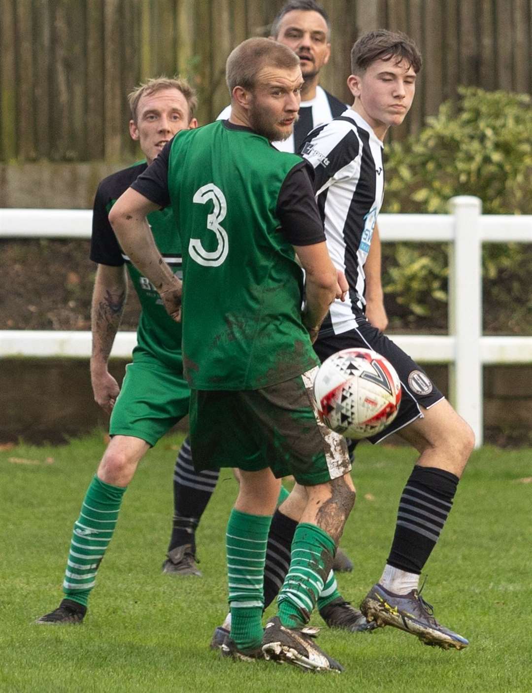 Defence and attack watch on as Emre Upston's shot passes goal-wards in the game between Swaffham Reserves and Horsford