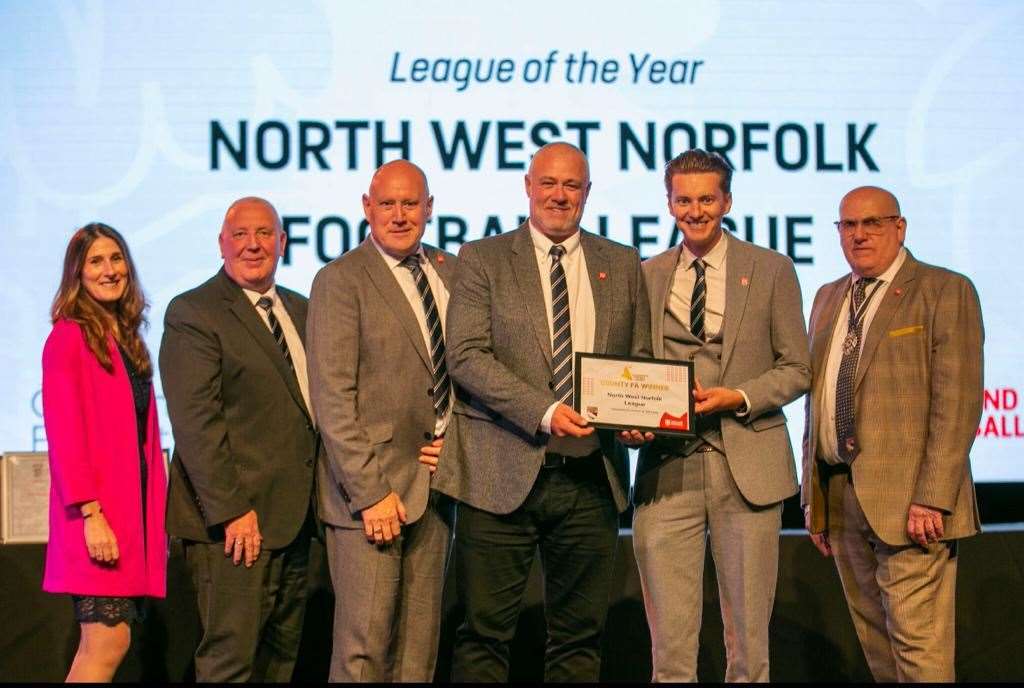 North West Norfolk League officials collect the League of the Year Award for 2023