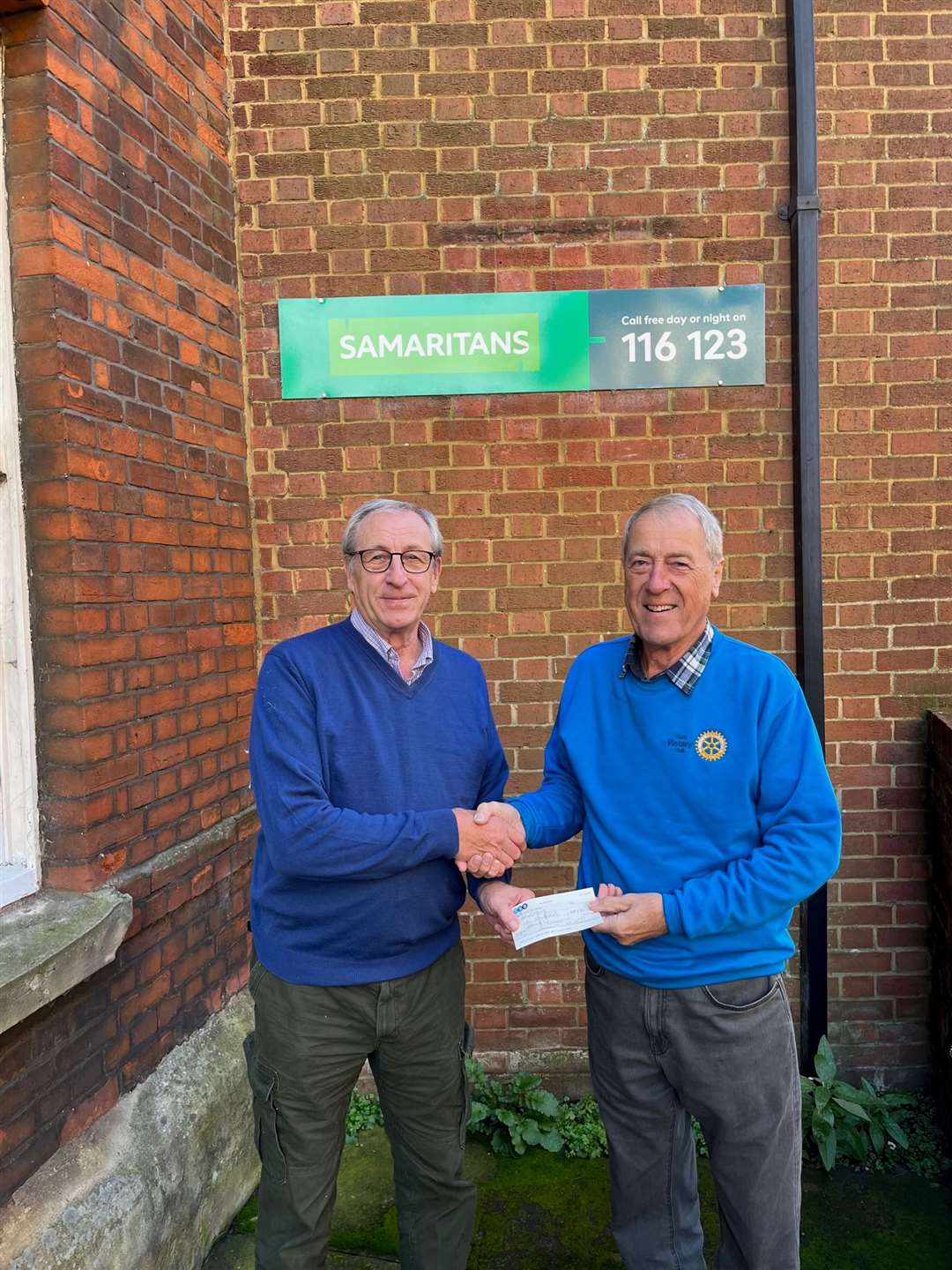 King's Lynn Samaritans branch director David Conner (Left) being handed a check by Rotarian Bob Foster (Right) Picture: Trinity Rotary King's Lynn