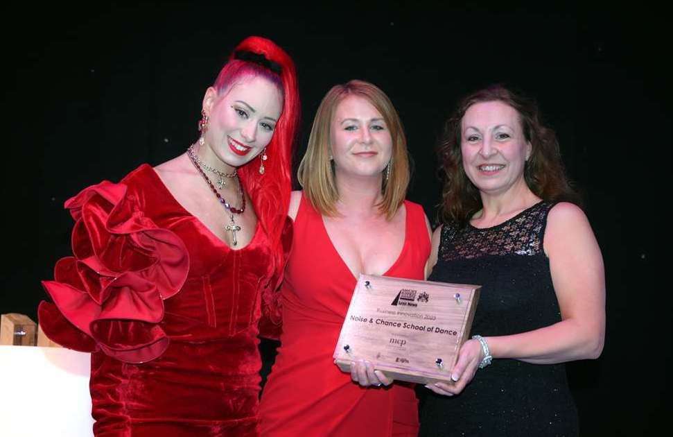 Emily Penman (left) and Trina Lee (right) of Noise & Chance School of Dance celebrate their win with Claire James of MCP Solicitors at this year's awards