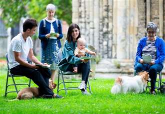 Dogs and a guinea pig are blessed at pet service