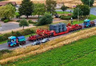 Drone footage shows 178-tonne transporter being driven out of town