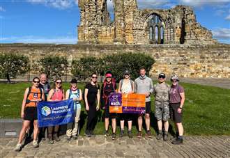 Firm takes a hike to raise £3,000 for charity