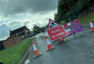 Burst water main results in closure of busy road into villages