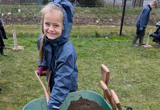 Pupils get hands on planting as part of their school’s garden project