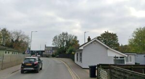 Road closed for hours after car crashed into house