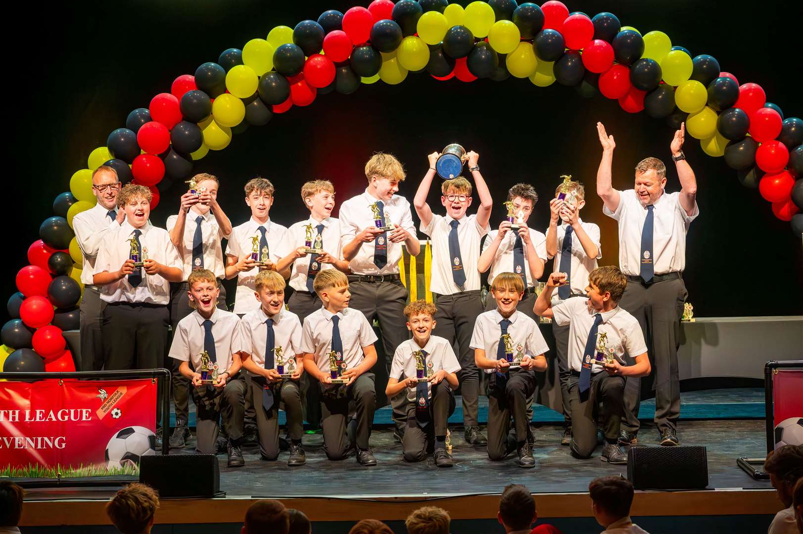 Youngsters from Clenchwarton under-13s last season celebrate their success on the pitch. Picture: Ian Burt
