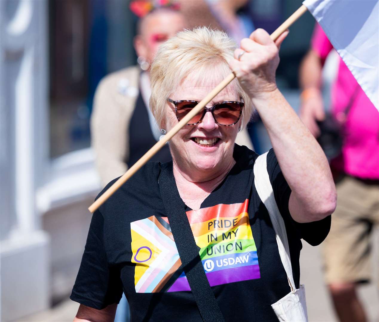 Flag waving as the parade marches on. Picture: Ian Burt