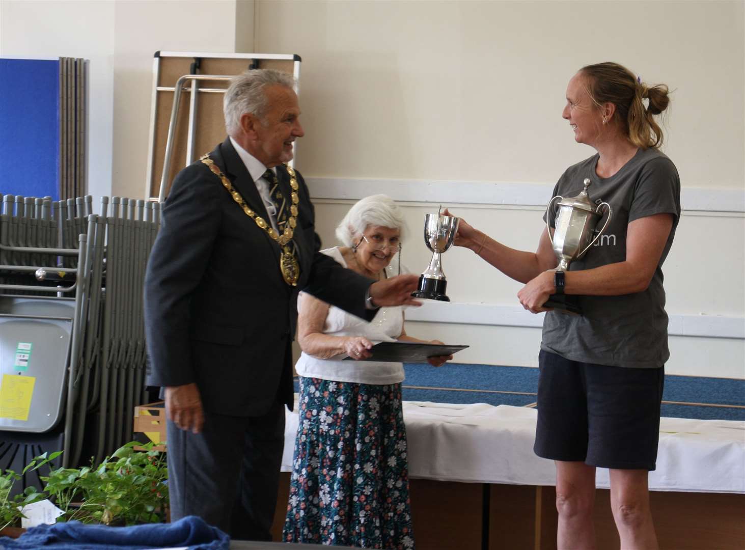 Selina Povey receiving some of her trophies from the mayor