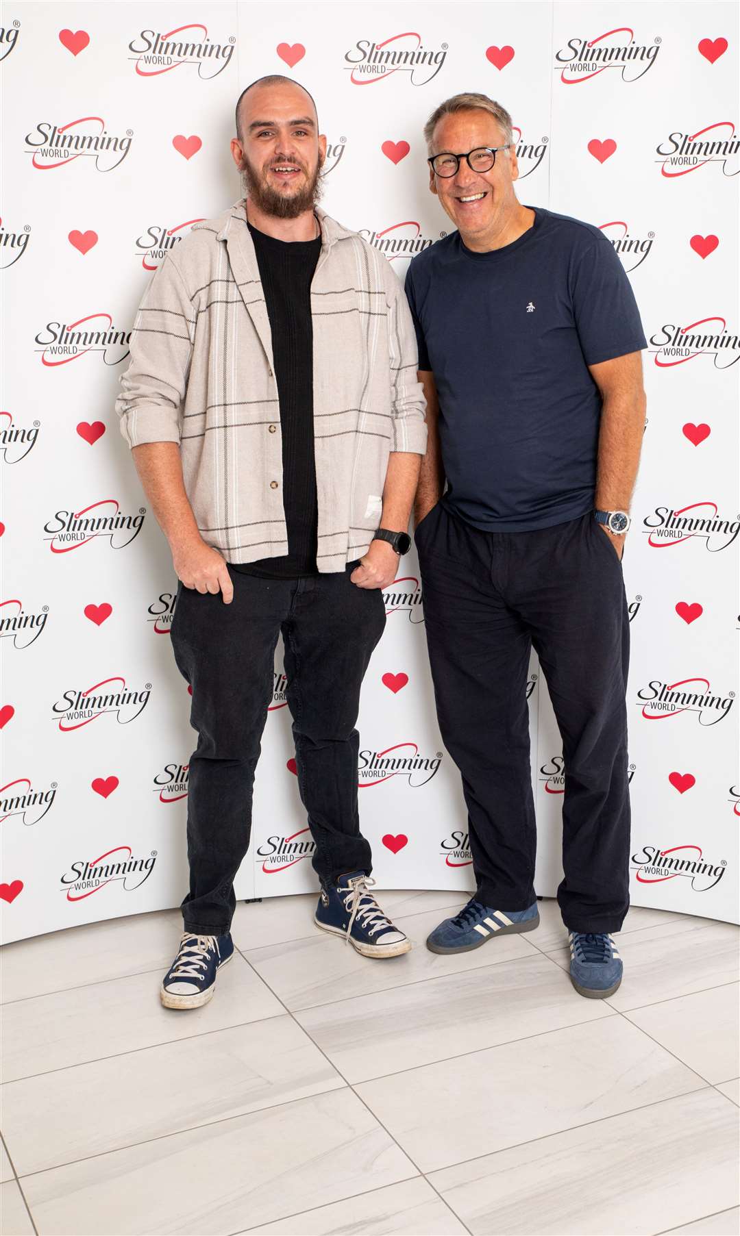 Jamie, left, being congratulated by former England and Arsenal star Paul Merson. Picture: Slimming World/Matt Lowe
