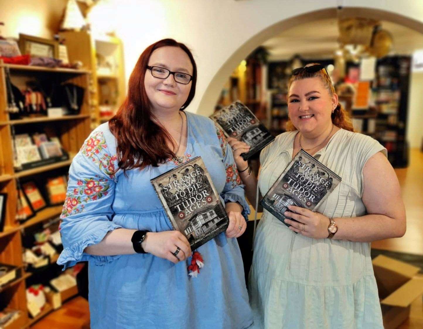 Debut co-authors Carrie Ingram-Gettins, left, and Emily Bush with copies of their book.