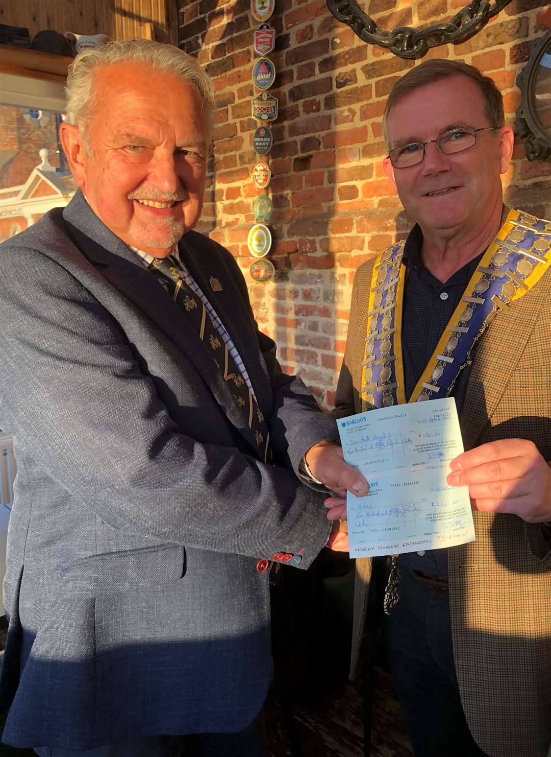 West Norfolk Mayor Cllr Andy Bullen, left, receiving cheques from Rotary president James Lee