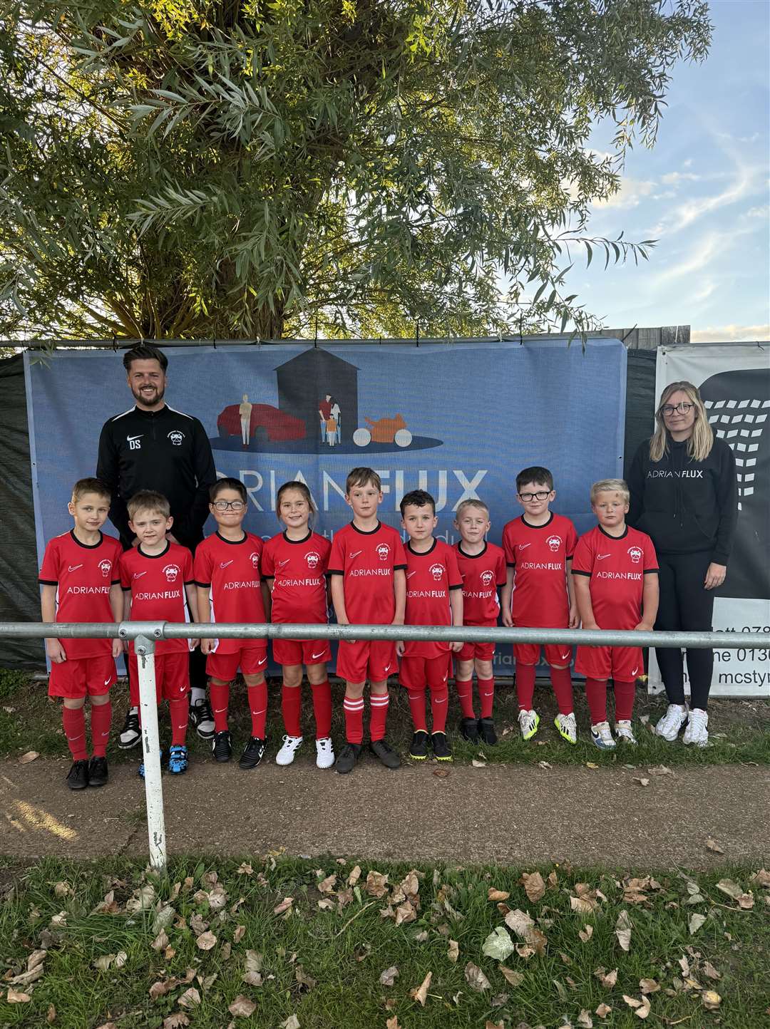 Downham Town under-7s. Pictured with the team is first team boss Dale Stokes and Jen Gosnell, marketing manager at Adrian Flux.