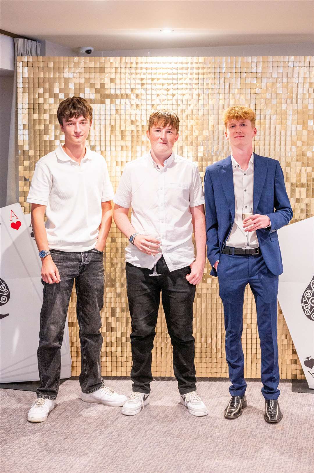 Commemorating prom night with a photo in front of the sequinned backdrop
