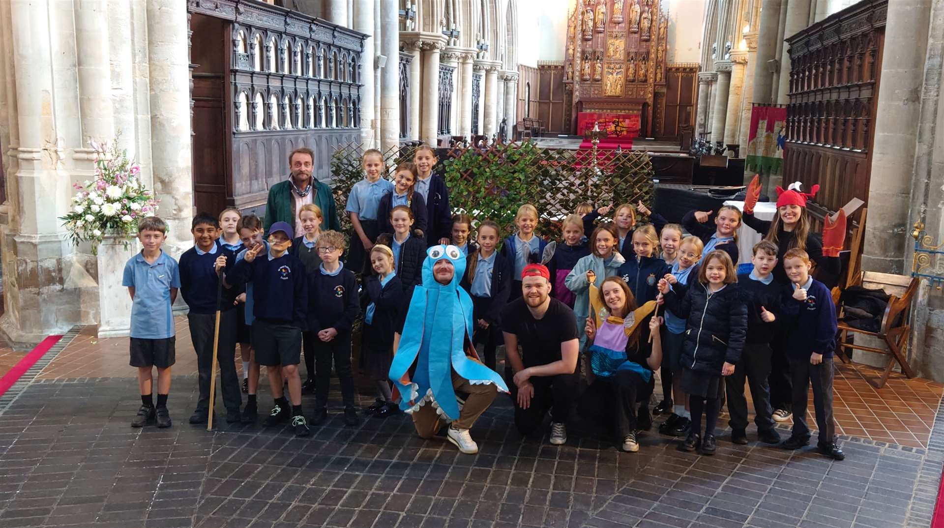 Youngsters from Docking Primary Academy with performers and Tim FitzHigham inside Lynn Minster celebrating the life of Robert Armin. Picture: West Norfolk Council
